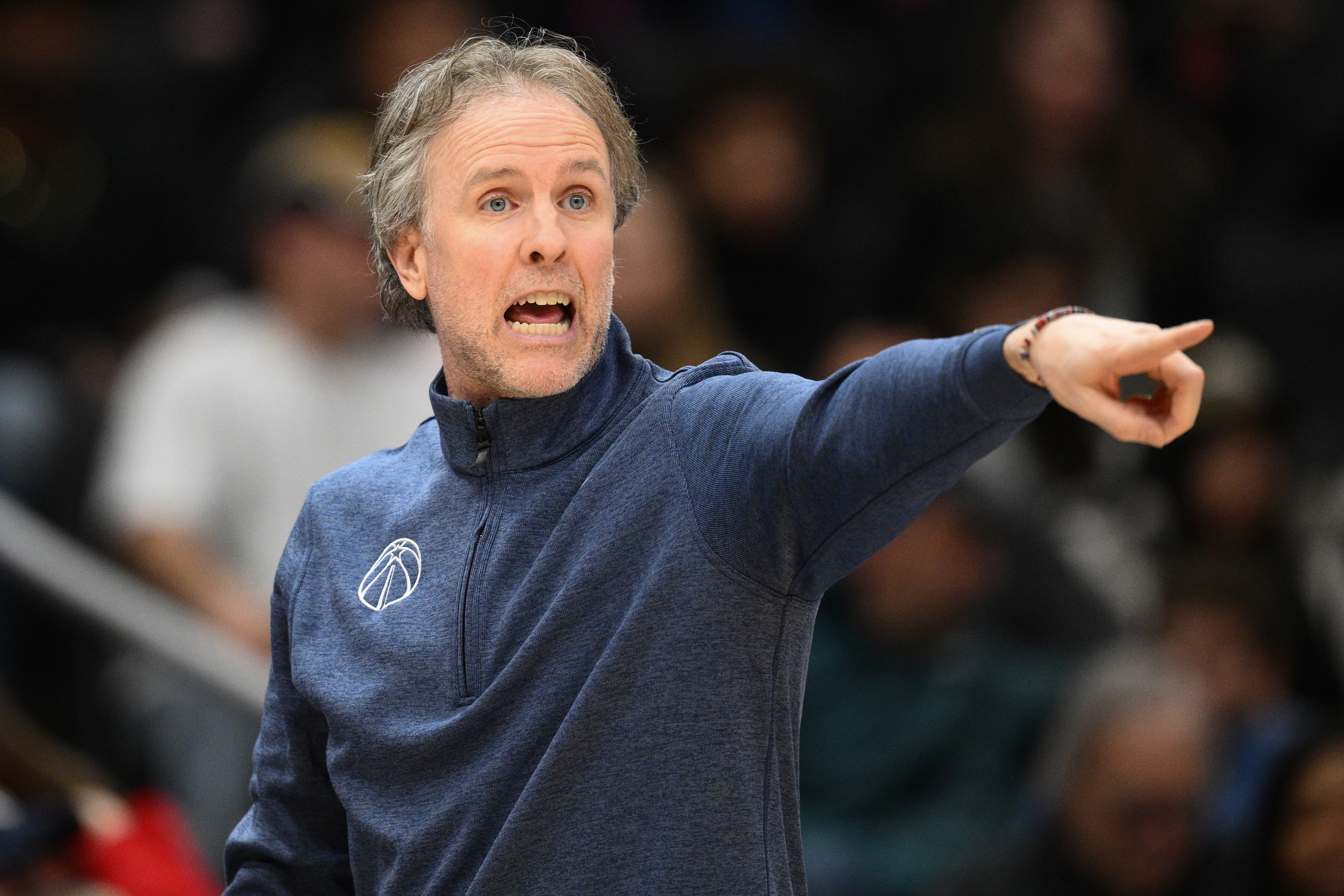 Washington Wizards head coach Brian Keefe points from the sideline...