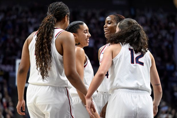 UConn's Sarah Strong, left, Azzi Fudd, center left, Blanca Quinonez, center right, and Ashlynn Shade, right, celebrate in the first half of an NCAA college basketball game against Notre Dame, Monday, Jan. 19, 2026, in Storrs, Conn. (AP Photo/Jessica Hill)