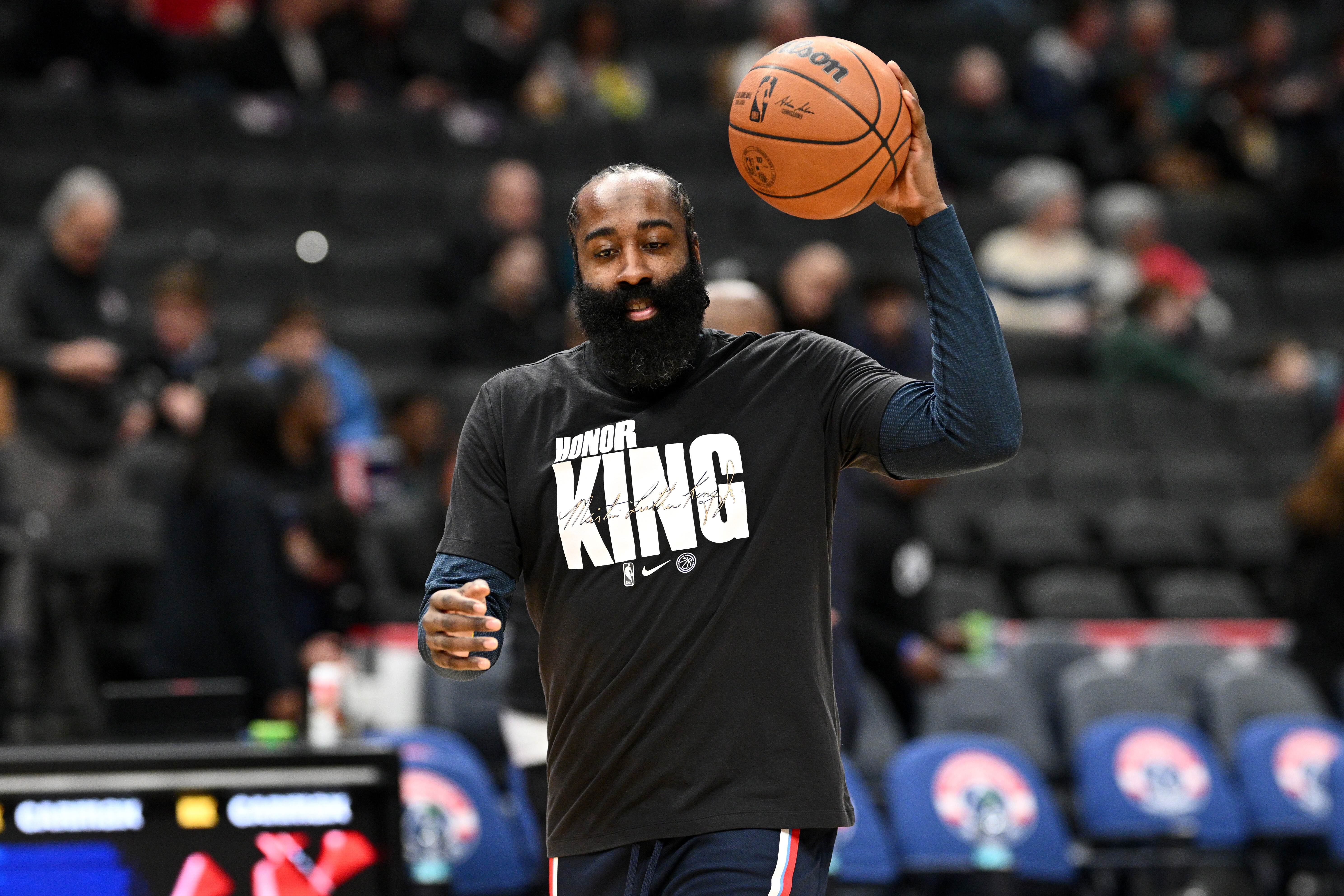 Clippers guard James Harden warms up while wearing a shirt...