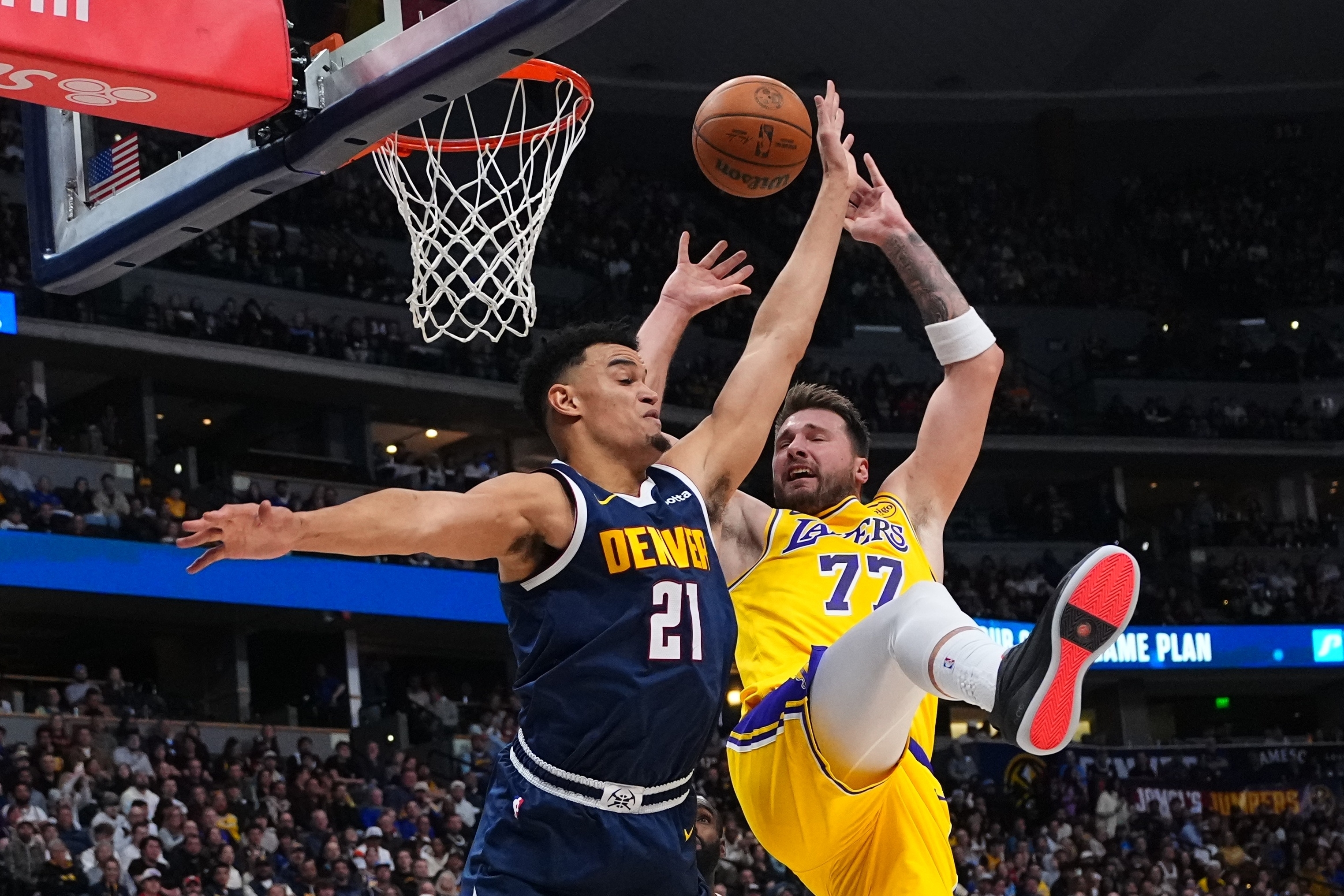 Denver Nuggets forward Spencer Jones, left, fouls Lakers forward Luka...