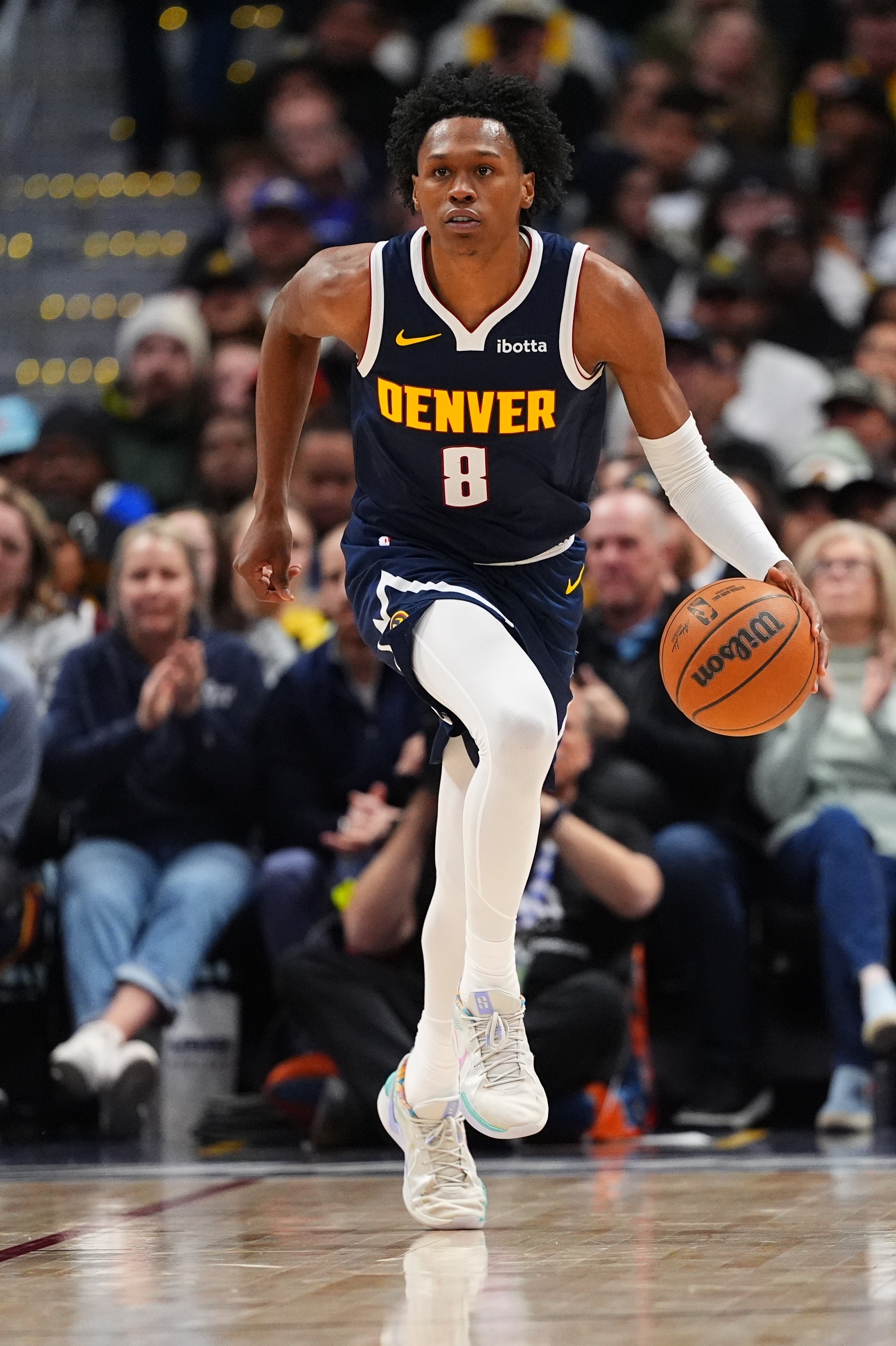 Denver Nuggets guard Peyton Watson brings the ball up court...