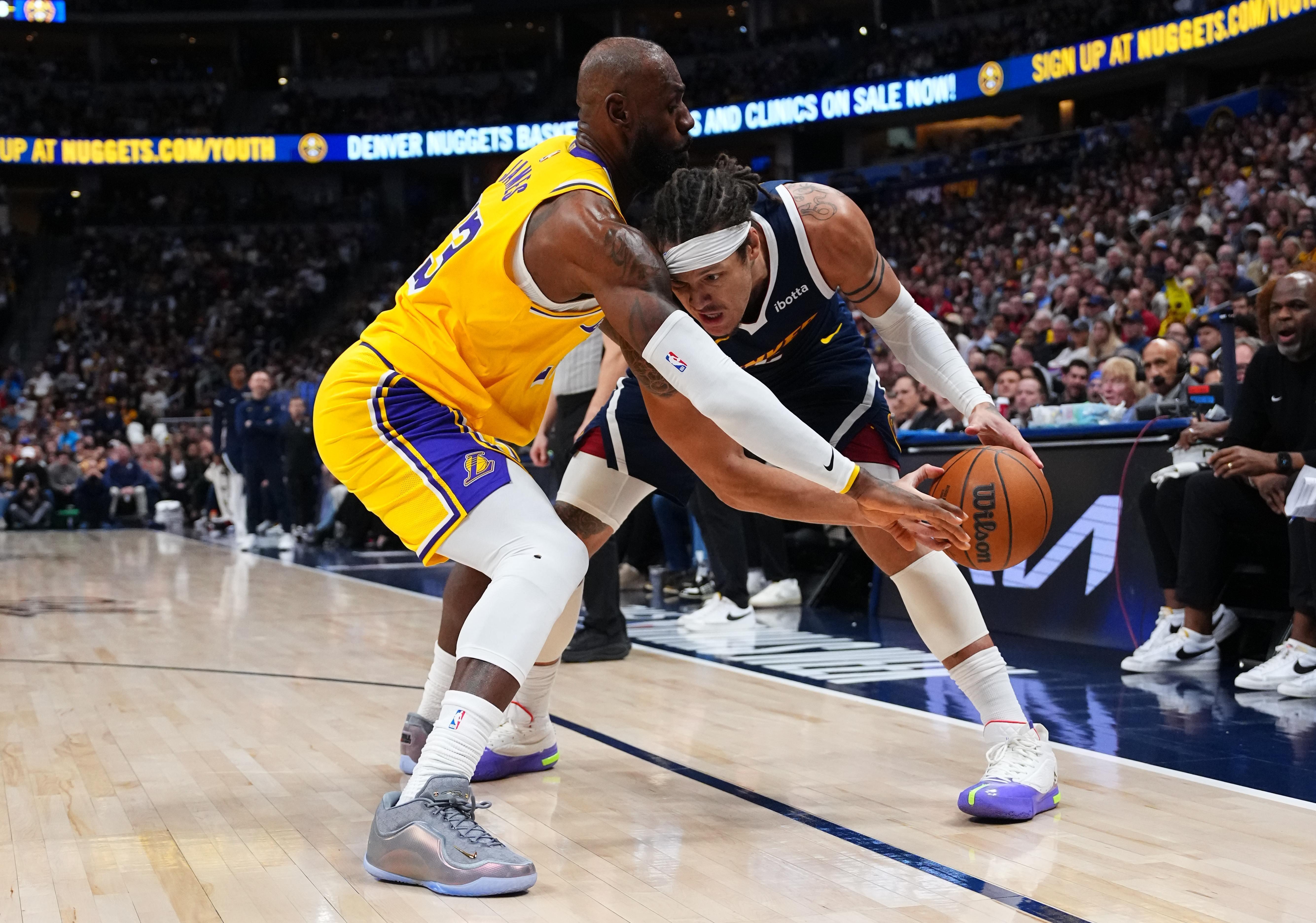 Denver Nuggets forward Aaron Gordon (32) collides with Lakers forward...
