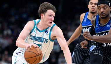 Charlotte Hornets guard Kon Knueppel, left, drives to the basket as Orlando Magic center Wendell Carter Jr., right, and forward Noah Penda, second from right, defend during the first half of an NBA basketball game, Thursday, Jan. 22, 2026, in Orlando, Fla. (AP Photo/Phelan M. Ebenhack)