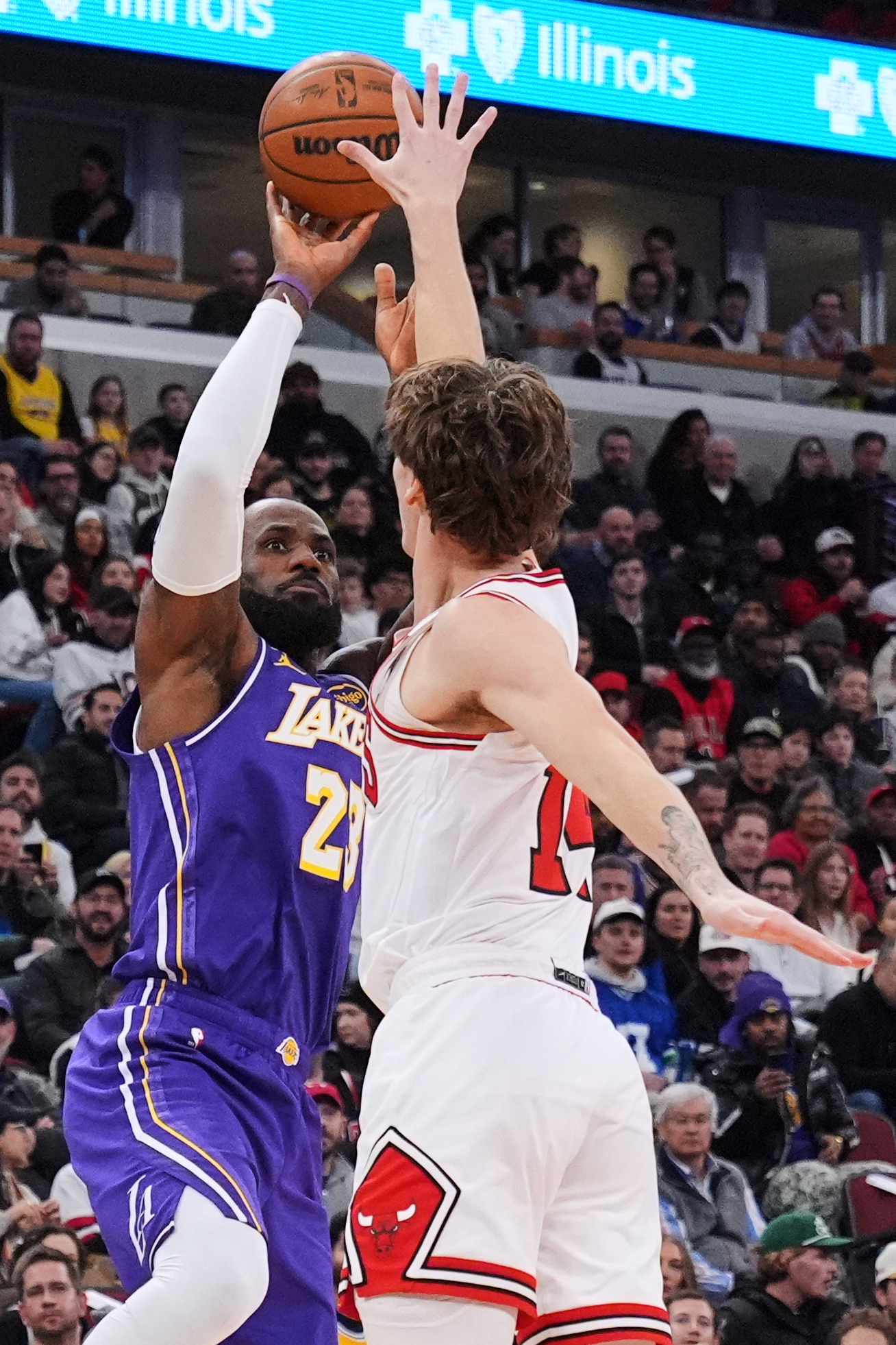 Lakers forward LeBron James, left, shoots as Chicago Bulls forward...