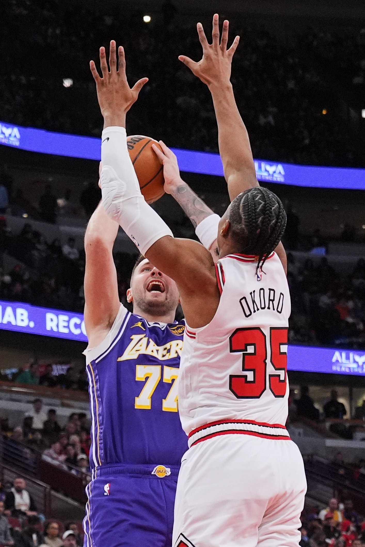 Lakers guard Luka Doncic, left, looks to shoot as Chicago...