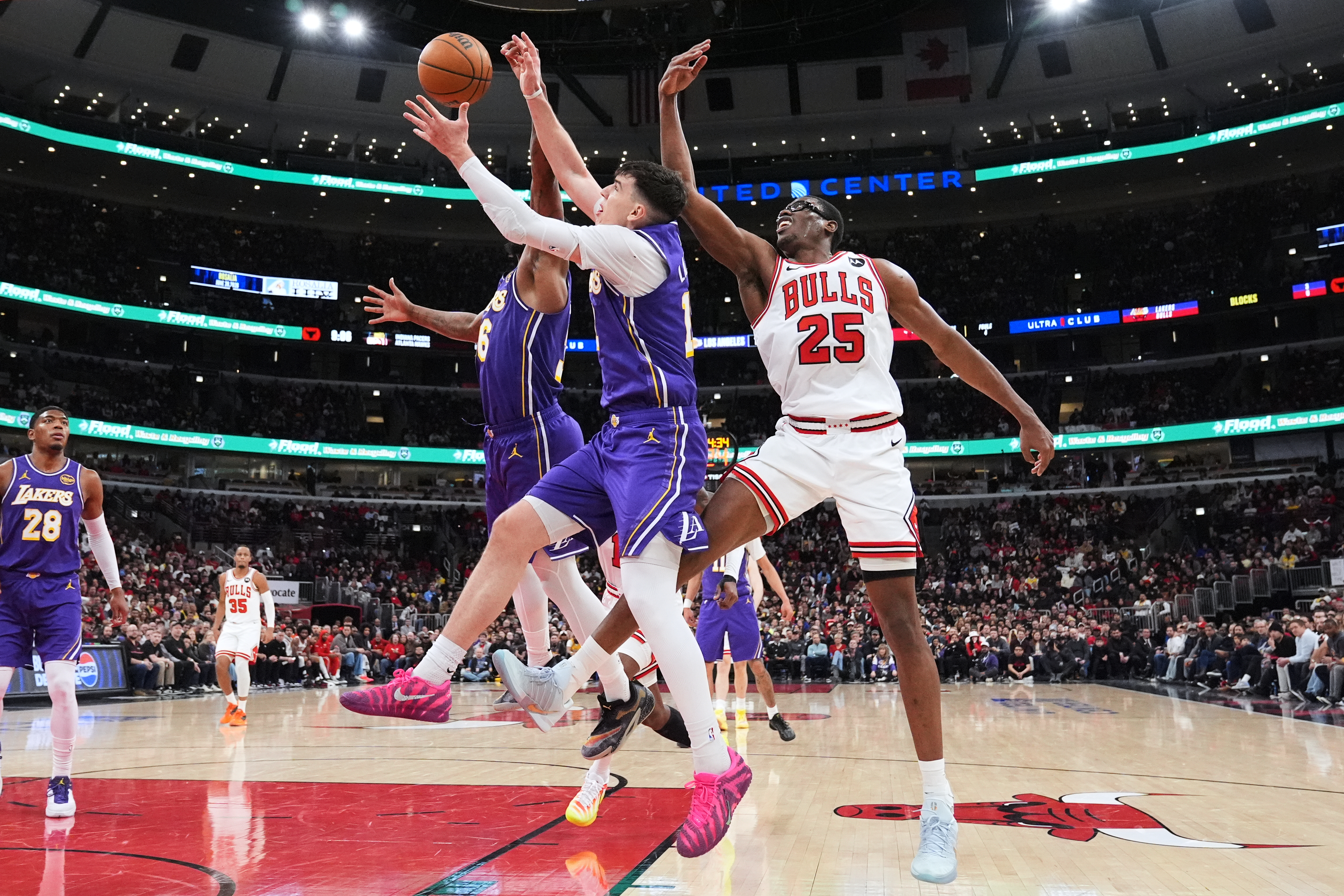 Lakers forward Jake LaRavia, center, battles for a rebound against...