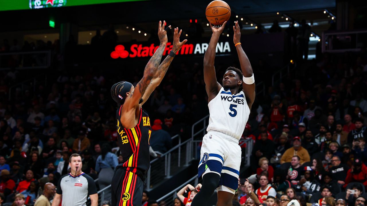 Minnesota Timberwolves guard Anthony Edwards (5) shoots over Atlanta Hawks guard Nickeil Alexander-Walker during the first half of an NBA basketball game, Wednesday, Dec. 31, 2025, in Atlanta. (AP Photo/Colin Hubbard)