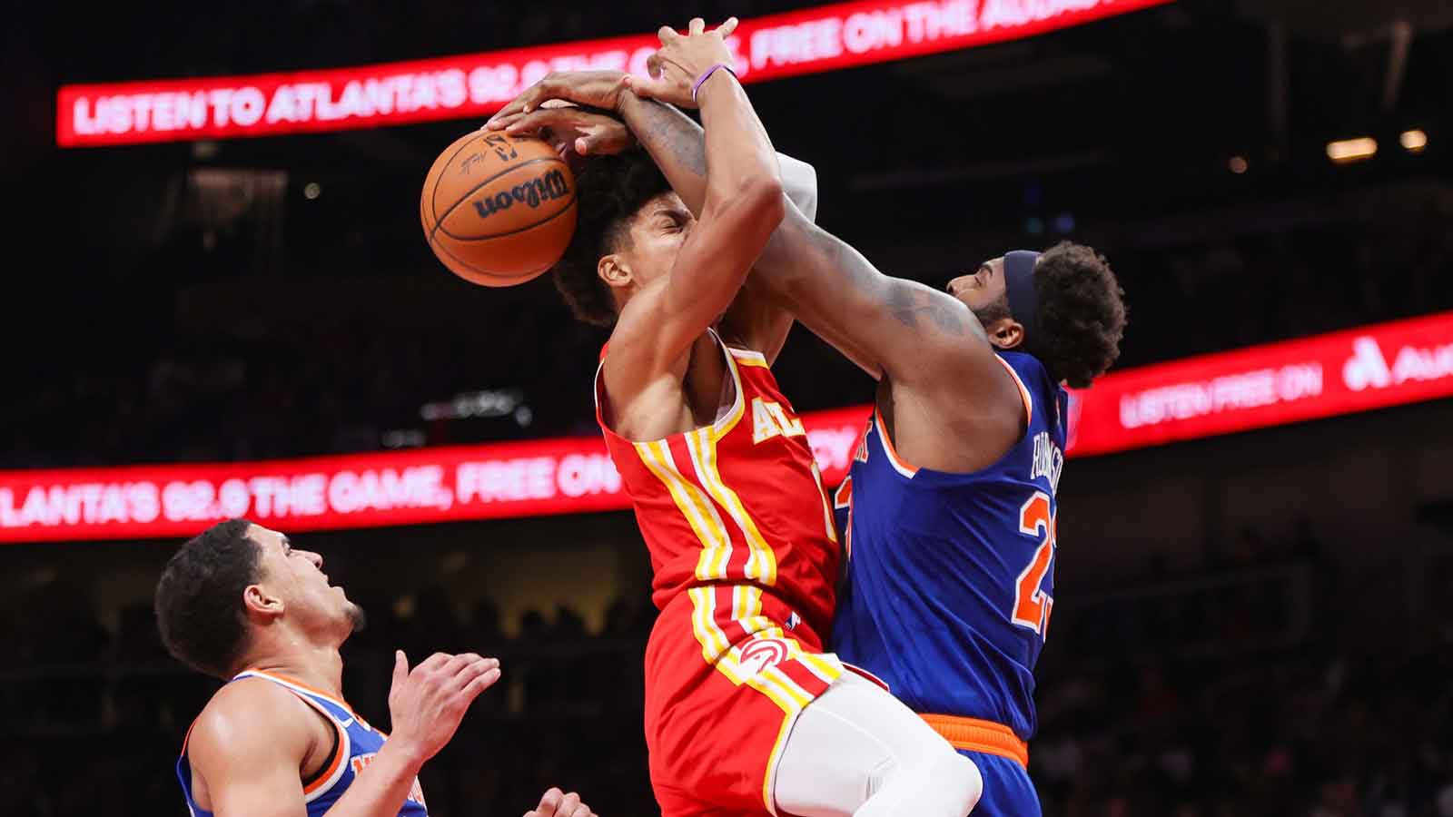 Atlanta Hawks forward Jalen Johnson (1) is defended by New York Knicks center Mitchell Robinson (23) in the third quarter at State Farm Arena.