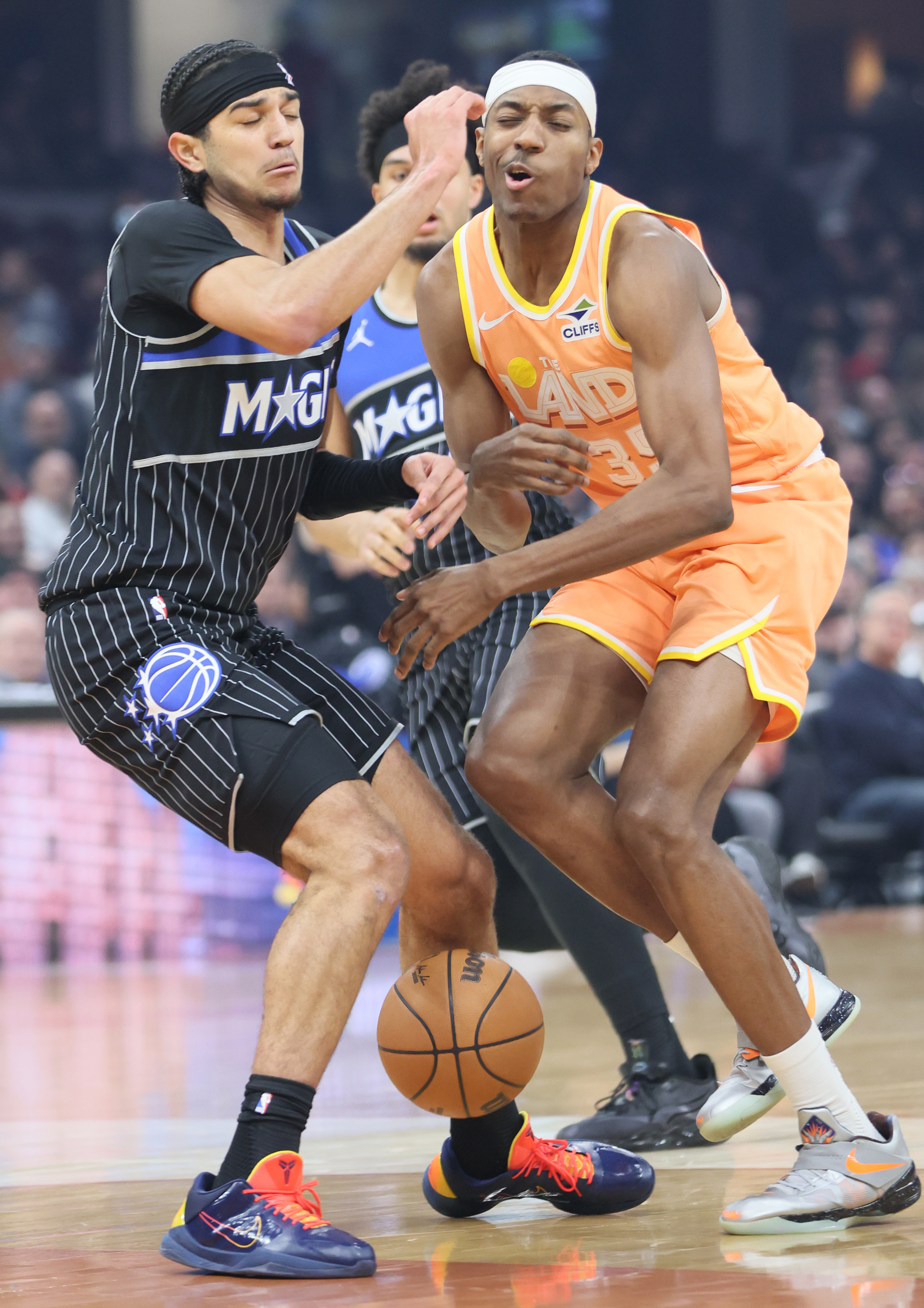 Cleveland Cavaliers forward Nae'qwan Tomlin (R) loses control of his dribble guarded by Orlando Magic guard Anthony Black in the first half at Rocket Arena. 