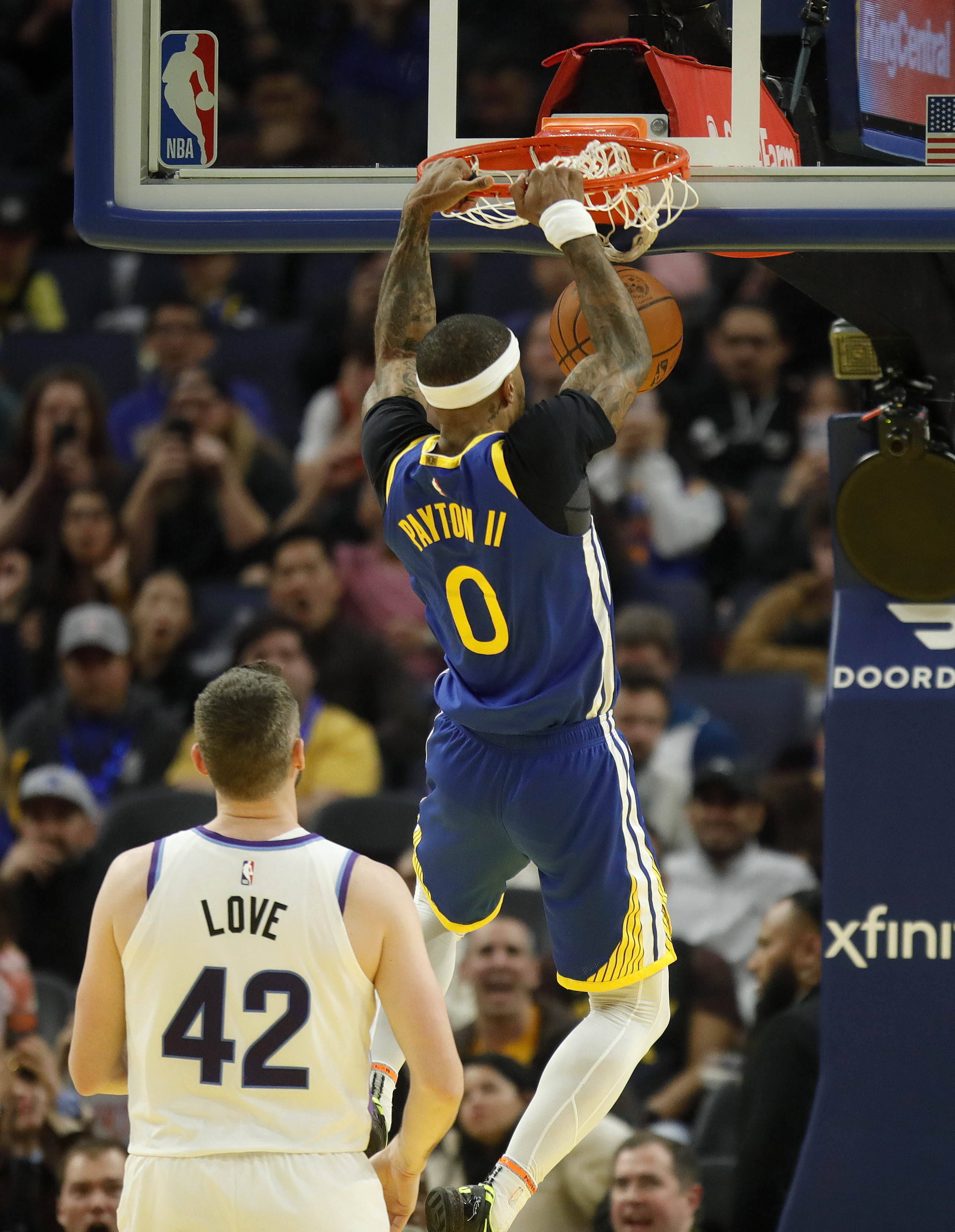 Golden State Warriors’ Gary Payton II #0 dunks past Utah...