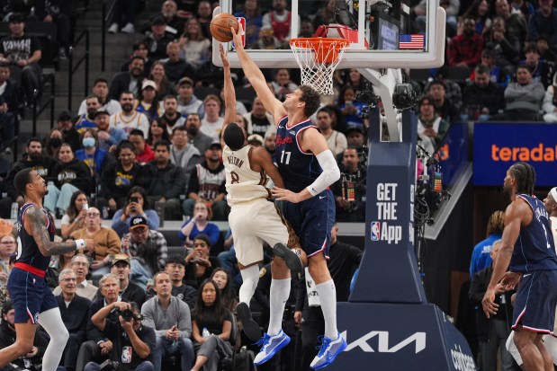 Los Angeles Clippers center Brook Lopez (11) blocks a shot by Golden State Warriors guard De'anthony Melton (8) during the first half of an NBA basketball game Monday, Jan. 5, 2026, in Inglewood, Calif. (AP Photo/Jae C. Hong)