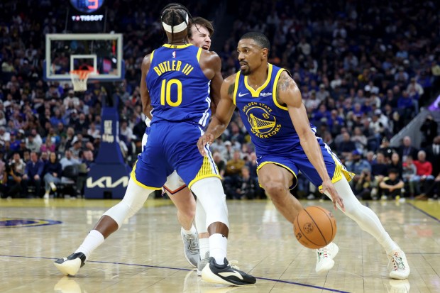 Golden State Warriors' De'Anthony Melton (8) dribbles around as Golden State Warriors' Jimmy Butler III (10) blocks New York Knicks' Tyler Kolek (13) in the second quarter of an NBA game at Chase Center in San Francisco, Calif., on Thursday, Jan. 15, 2026. (Ray Chavez/Bay Area News Group)