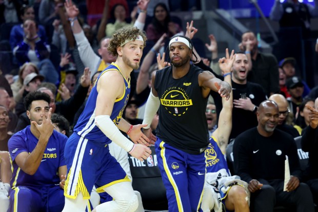 Golden State Warriors' Brandin Podziemski (2) celebrates with teammates after scoring a three-point basklet against the New York Knicks in the second quarter of an NBA game at Chase Center in San Francisco, Calif., on Thursday, Jan. 15, 2026. (Ray Chavez/Bay Area News Group)