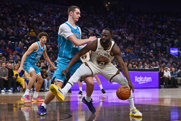 Golden State Warriors' Draymond Green (23) drives against Charlotte Hornets' Ryan Kalkbrenner (11) in the fourth quarter of their NBA game at Chase Center in San Francisco, Calif., on Saturday, Jan. 17, 2026. The Golden State Warriors defeated the Charlotte Hornets 136-116. (Jose Carlos Fajardo/Bay Area News Group)