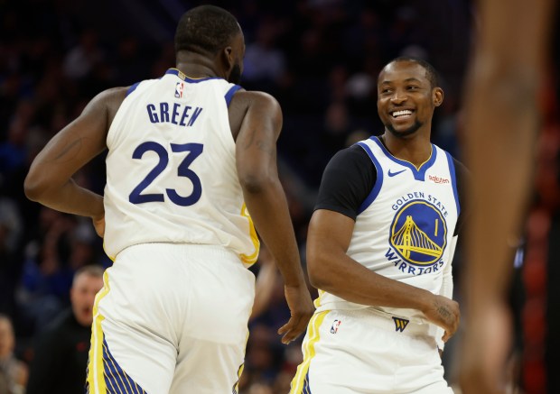 Golden State Warriors' Jonathan Kuminga (1) smiles at Golden State Warriors' Draymond Green (23) after making a basket against the Toronto Raptors in the third quarter at the Chase Center in San Francisco, Calif., on Tuesday, Jan. 20, 2026. (Nhat V. Meyer/Bay Area News Group)