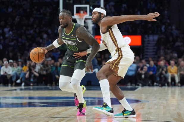Minnesota Timberwolves forward Julius Randle (30) works toward the basket as Golden State Warriors guard Buddy Hield, right, defends during the first half of an NBA basketball game, Monday, Jan. 26, 2026, in Minneapolis. (AP Photo/Abbie Parr)