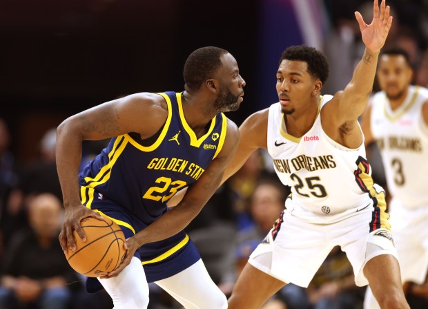 Golden State Warriors' Draymond Green (23) is guarded by New Orleans Pelicans' Trey Murphy III (25), Friday, April 12, 2024, at Chase Center in San Francisco, Calif. (Karl Mondon/Bay Area News Group)