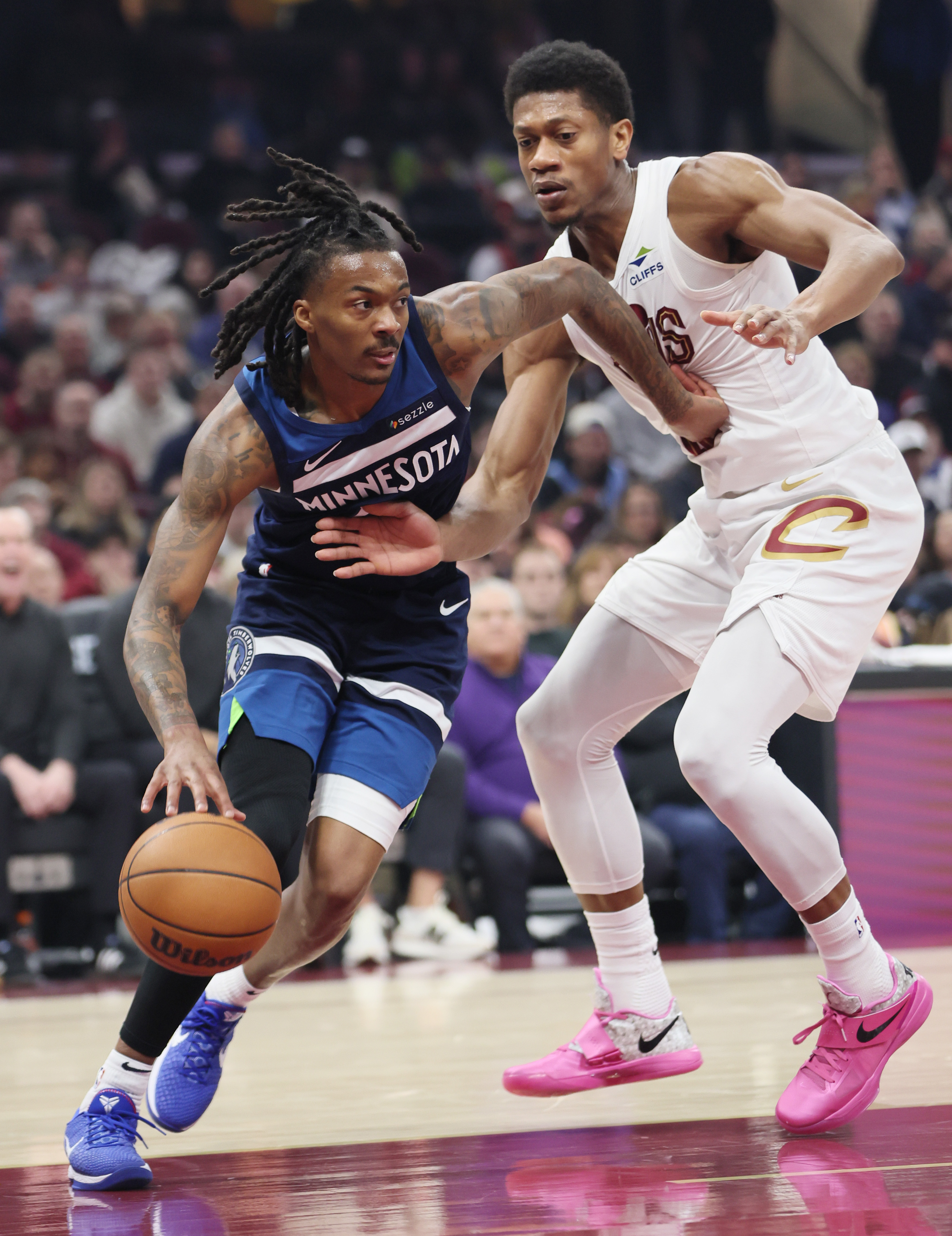 Minnesota Timberwolves guard Bones Hyland drives towards the basket guarded by Cleveland Cavaliers forward De'andre Hunter in the first half at Rocket Arena. 