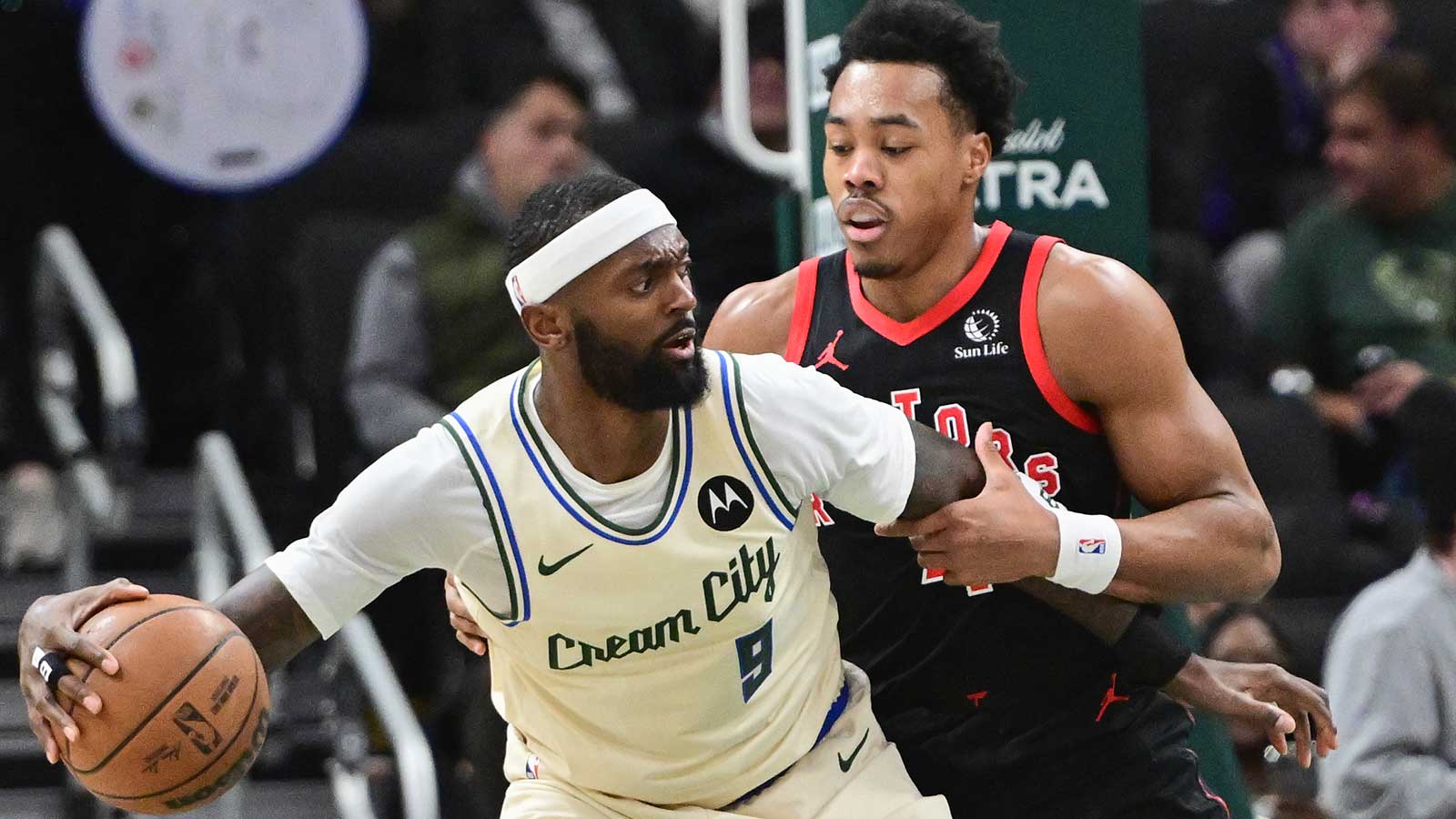 Milwaukee Bucks forward Bobby Portis (9) dribbles against Toronto Raptors guard Scottie Barnes (4) in the second quarter at Fiserv Forum.