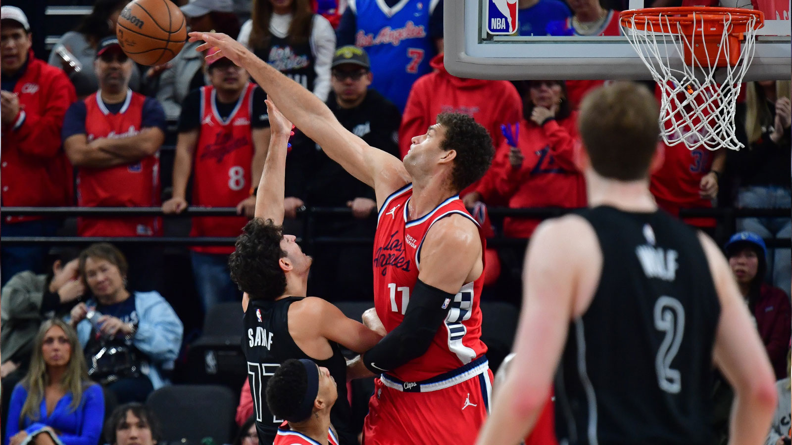 Los Angeles Clippers center Brook Lopez (11) blocks the shot of Brooklyn Nets guard Ben Saraf (77) during the first half at Intuit Dome.