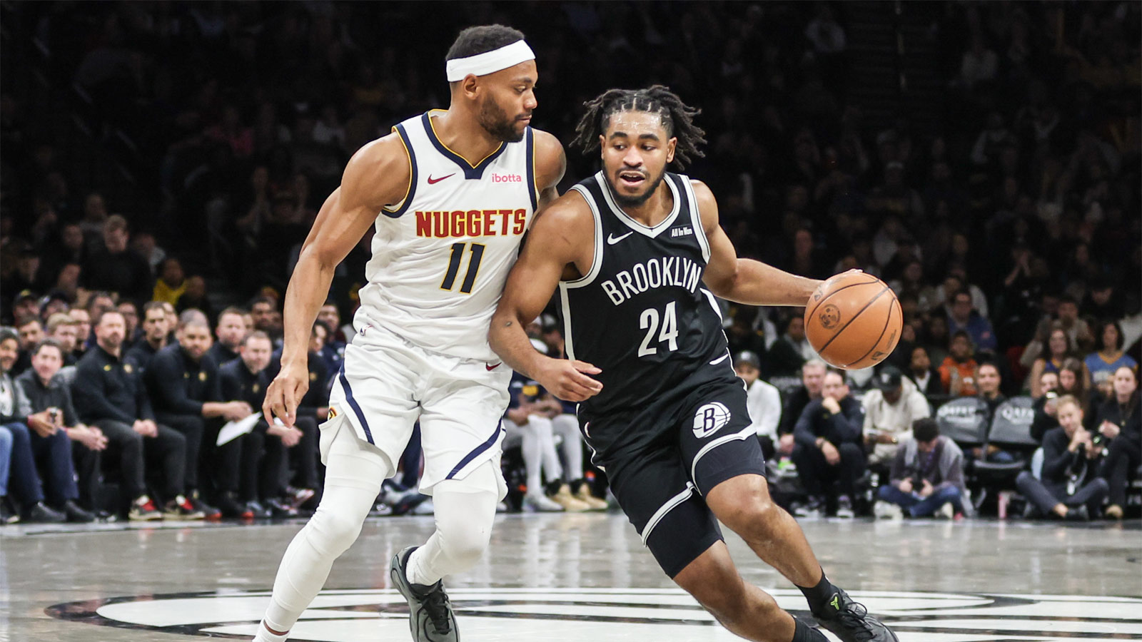 Brooklyn Nets guard Cam Thomas (24) drives past Denver Nuggets guard Curtis Jones (1) in the fourth quarter at Barclays Center.