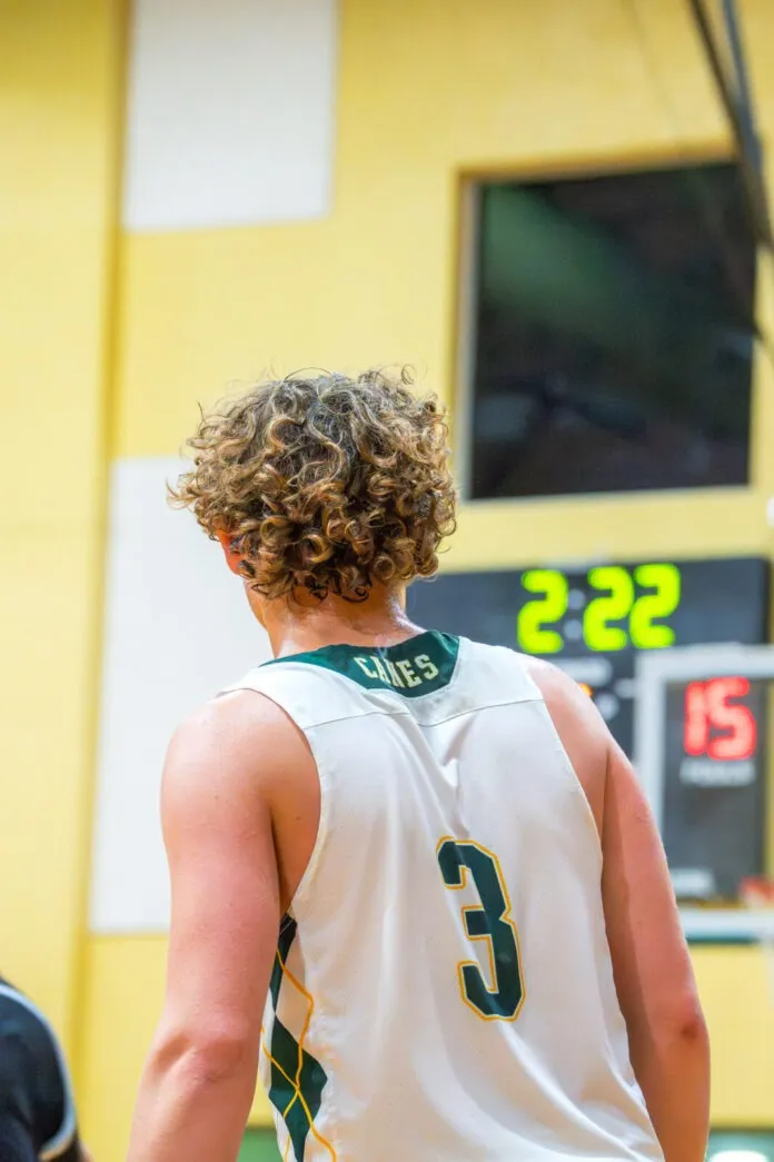 a man in a basketball uniform standing on a court