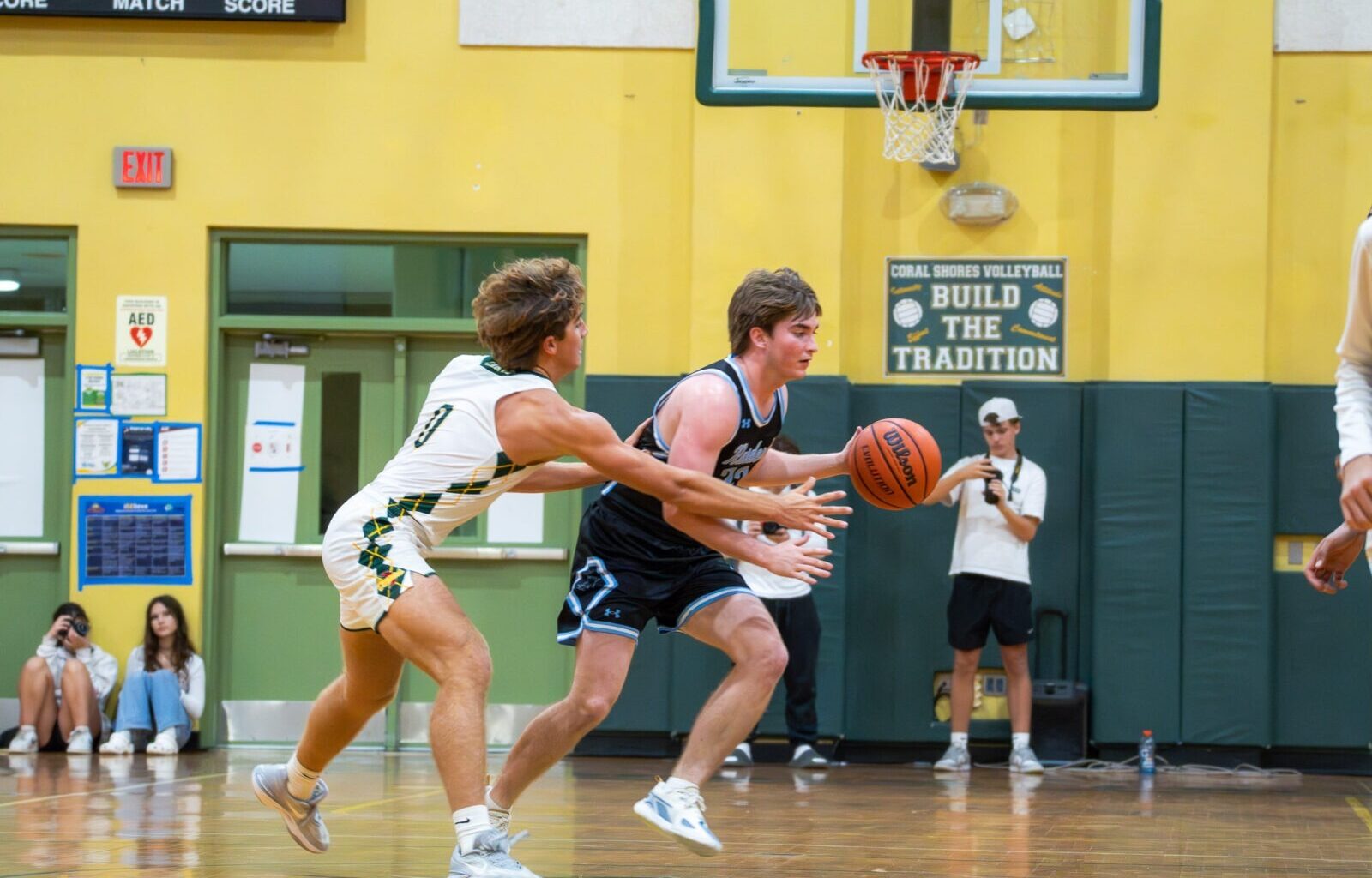a group of young men playing a game of basketball
