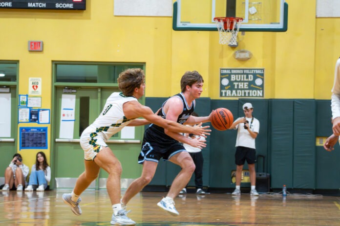 a group of young men playing a game of basketball