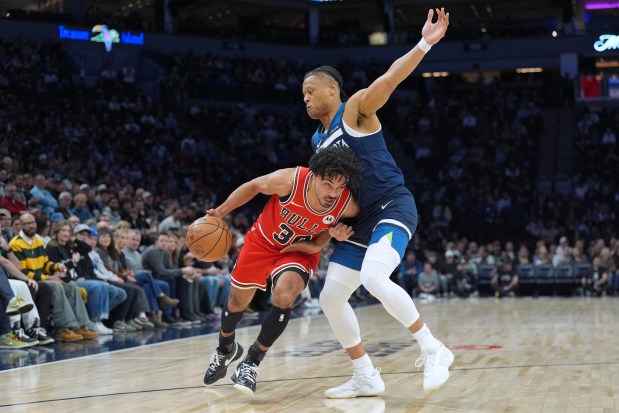 Bulls guard Tre Jones works toward the basket as the Timberwolves' Jaylen Clark defends during the first half on Jan. 22, 2026, in Minneapolis. (AP Photo/Abbie Parr)