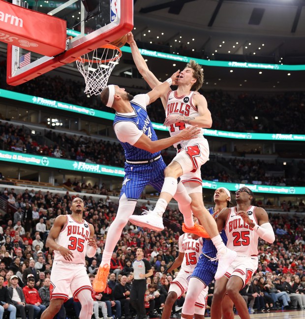 Bulls forward Matas Buzelis dunks over the defense of Magic guard Jalen Suggs in the second quarter at the United Center on Jan. 2, 2026, in Chicago. (John J. Kim/Chicago Tribune)