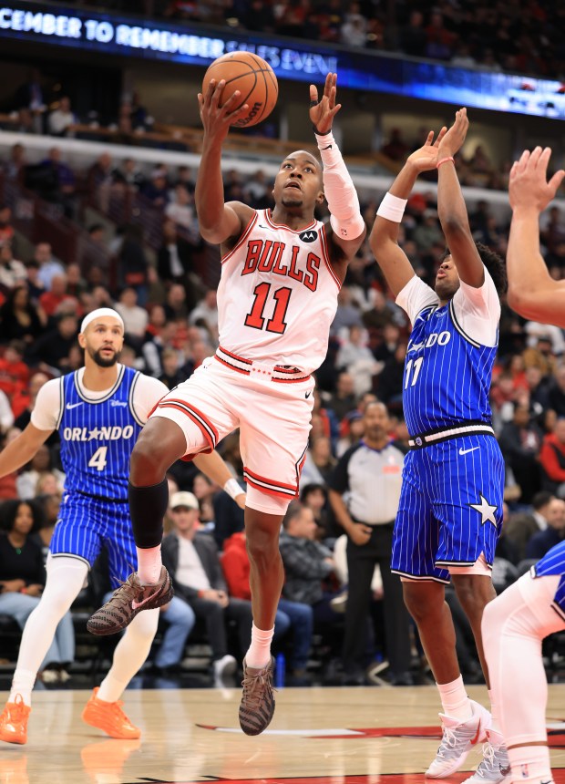 Bulls guard Ayo Dosunmu rises for a layup as Magic guard Jase Richardson (11) defends in the second quarter at the United Center on Jan. 2, 2026, in Chicago. (John J. Kim/Chicago Tribune)
