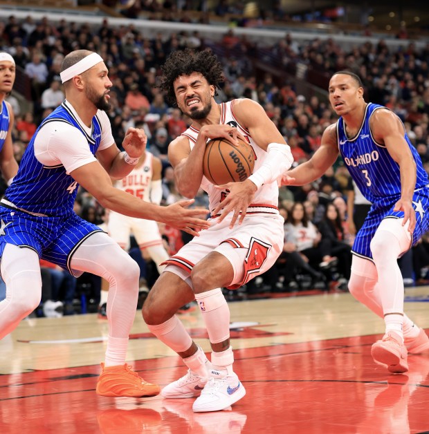 Bulls guard Tre Jones, center, is defended by Magic guard Jalen Suggs (4) in the first quarter at the United Center on Jan. 2, 2026, in Chicago. (John J. Kim/Chicago Tribune)