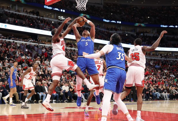 Magic forward Paolo Banchero (5) is blocked by Bulls forward Patrick Williams in the third quarter at the United Center on Jan. 2, 2026, in Chicago. (John J. Kim/Chicago Tribune)