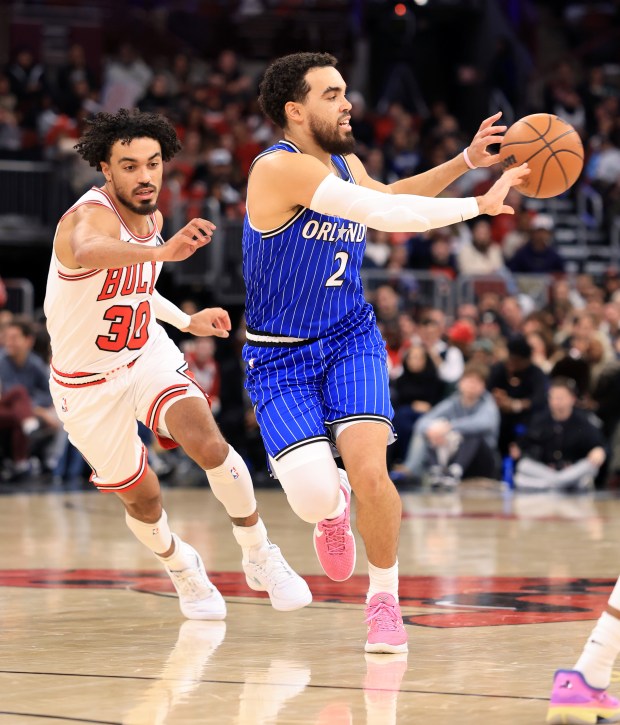 Magic guard Tyus Jones (2) passes the ball while being chased by his brother, Bulls guard Tre Jones (30), in the fourth quarter at the United Center on Jan. 2, 2026, in Chicago. (John J. Kim/Chicago Tribune)