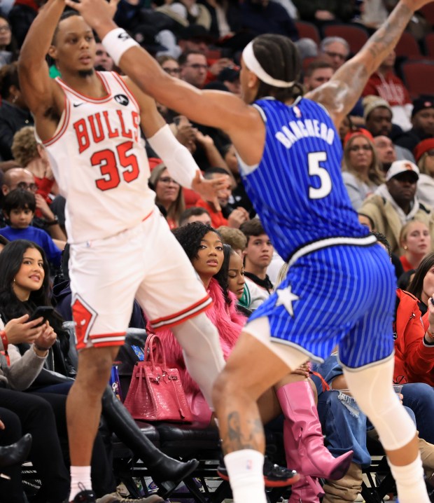 Chicago Sky player Angel Reese, center, watches the fourth quarter of a Bulls-Magic game at the United Center on Jan. 2, 2026, in Chicago. (John J. Kim/Chicago Tribune)
