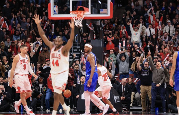Bulls fans and players celebrate a dunk from forward Isaac Okoro in the final basket of the game for a 121-114 win over the Magic at the United Center on Jan. 2, 2026, in Chicago. (John J. Kim/Chicago Tribune)