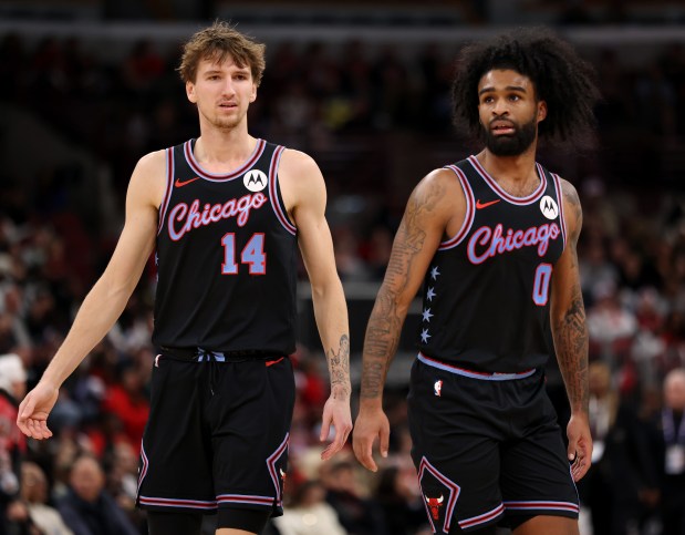 Bulls forward Matas Buzelis (14) and guard Coby White head to the bench against the Pacers on Dec. 5, 2025, at the United Center. (John J. Kim/Chicago Tribune)