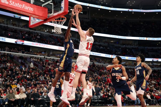 Bulls guard/forward Kevin Huerter (13) puts up a shot as Pelicans center Yves Missi (21) defends in the first half at the United Center on Wednesday, Dec. 31, 2025. (Terrence Antonio James/Chicago Tribune)