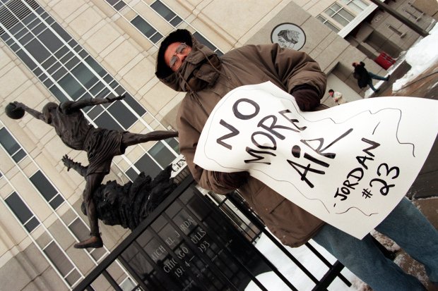 Tony Martinez, of Chicago, holds a "No More Air" sign on Jan. 13, 1999, at the United Center in Chicago, as Michael Jordan announced his retirement. (Chris Walker/Chicago Tribune)