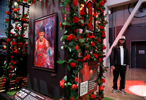 Derrick Rose takes a quick peek at the United Center atrium, decorated in his honor, prior to his #1 jersey being retired by the Chicago Bulls in a ceremony scheduled for after a game between the Bulls and the Boston Celtics on Jan. 24, 2026. (Chris Sweda/Chicago Tribune)
