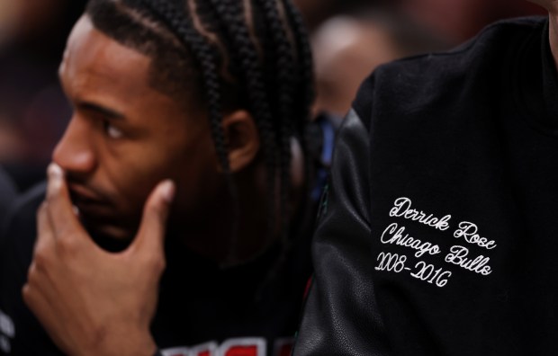 Chicago Bulls players wear custom-made jackets on the bench in honor of Derrick Rose in the first half of a game between the Bulls and the Boston Celtics at the United Center in Chicago on Jan. 24, 2026. The Bulls are retiring Rose's #1 jersey after the game. (Chris Sweda/Chicago Tribune)