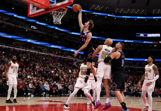 Chicago Bulls forward Matas Buzelis (14) sails through the air before missing a dunk in the first half of a game against the Boston Celtics at the United Center in Chicago on Jan. 24, 2026. (Chris Sweda/Chicago Tribune)