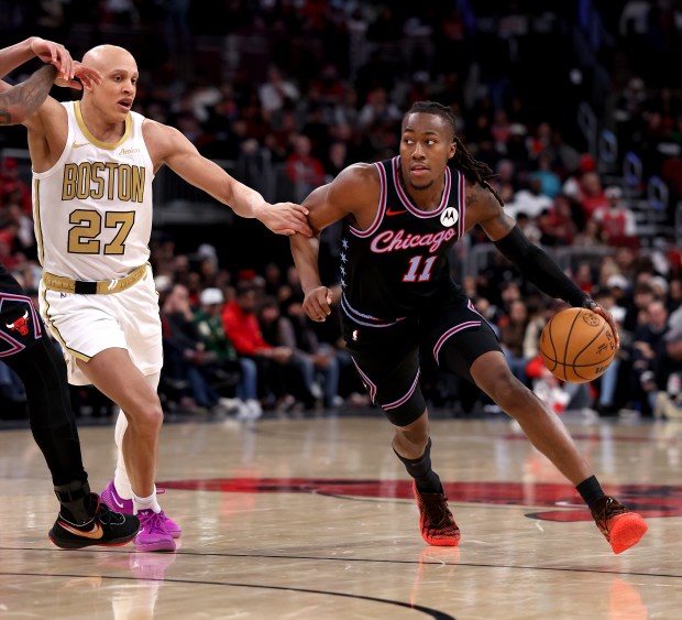 Chicago Bulls guard Ayo Dosunmu (11) drives on Boston Celtics guard Jordan Walsh (27) in the first half of a game at the United Center in Chicago on Jan. 24, 2026. (Chris Sweda/Chicago Tribune)