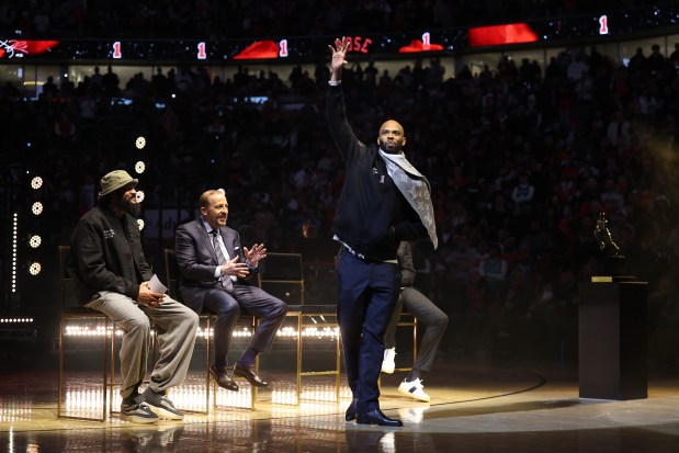 Taj Gibson waves to the crowd after honoring Derrick Rose with a speech as the Bulls held a ceremony to retire Rose's #1 jersey at the United Center in Chicago on Jan. 24, 2026. (Chris Sweda/Chicago Tribune)