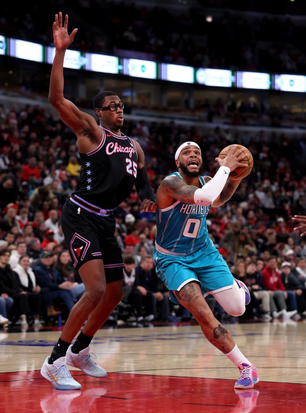 Charlotte Hornets forward Miles Bridges (0) drives on Chicago Bulls forward/center Jalen Smith (25) in the first half of a game at the United Center in Chicago on Jan. 3, 2026. (Chris Sweda/Chicago Tribune)