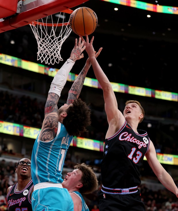 Charlotte Hornets guard Lamelo Ball (1) and Chicago Bulls guard/forward Kevin Huerter (13) battle for a rebound in the first half of a game at the United Center in Chicago on Jan. 3, 2026. (Chris Sweda/Chicago Tribune)