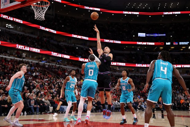 Chicago Bulls center Nikola Vučević (9) puts up a shot over Charlotte Hornets forward Miles Bridges (0) in the second half of a game at the United Center in Chicago on Jan. 3, 2026. (Chris Sweda/Chicago Tribune)