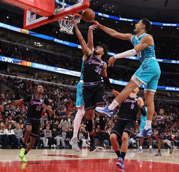 Chicago Bulls guard Tre Jones (30) has his layup attempt blocked by Charlotte Hornets guard Josh Green (10) in the second half of a game at the United Center in Chicago on Jan. 3, 2026. (Chris Sweda/Chicago Tribune)