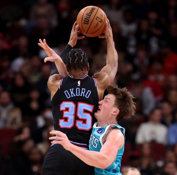 Charlotte Hornets guard/forward Kon Knueppel (7) runs into Chicago Bulls forward/guard Isaac Okoro (35) as Okoro grabs a rebound in the second half of a game at the United Center in Chicago on Jan. 3, 2026. (Chris Sweda/Chicago Tribune)