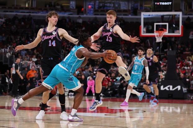 Charlotte Hornets guard Sion James (4) tries to pass the ball by Chicago Bulls forward Matas Buzelis (14) and guard/forward Kevin Huerter (13) in the second half of a game at the United Center in Chicago on Jan. 3, 2026. (Chris Sweda/Chicago Tribune)